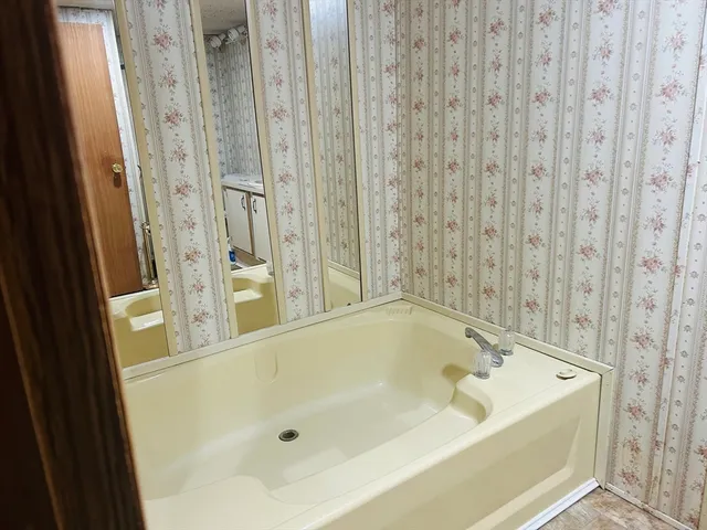 a bathroom with a toilet sink and shower curtain