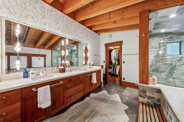 a large bathroom with a large window and sink