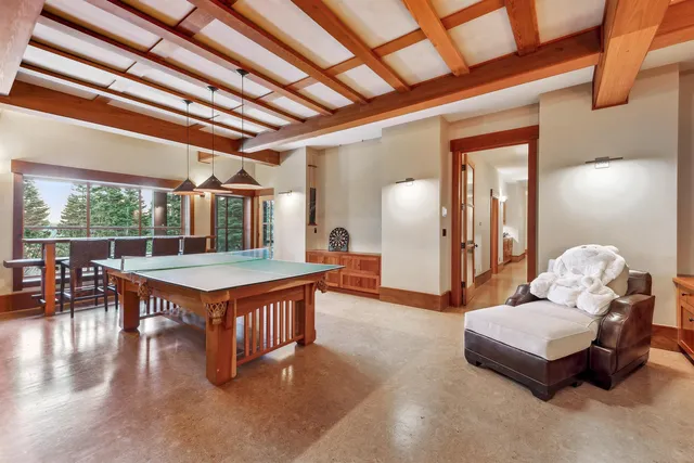 a living room with furniture a table tennis pool table and chairs