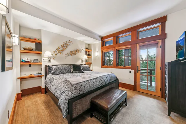 a bed sitting in a bedroom next to a window