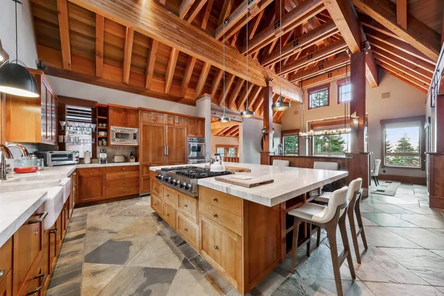 a kitchen with stainless steel appliances a stove a sink and a refrigerator