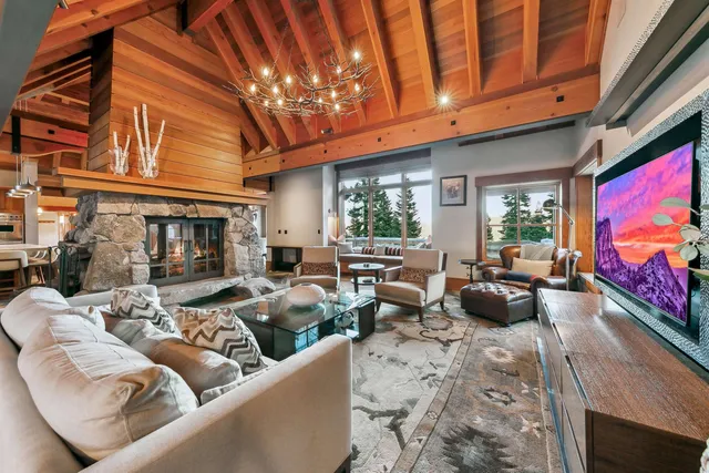 a living room with furniture a rug and a flat screen tv