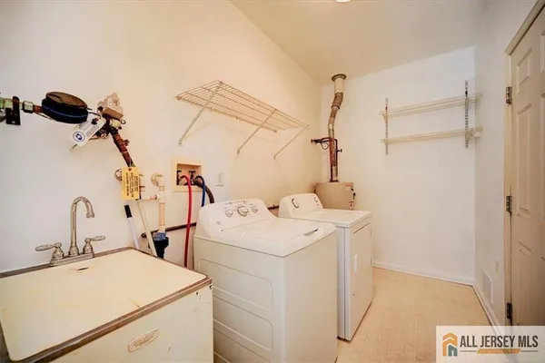 a view of a patio with a table and chairs under an umbrella