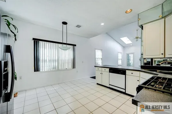 a kitchen with stainless steel appliances a refrigerator sink and microwave