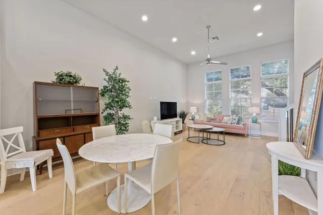 a kitchen with stainless steel appliances kitchen island granite countertop a stove a sink dishwasher and a refrigerator with wooden floor