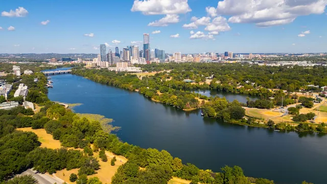 a view of a city with lots of residential buildings lake and ocean view