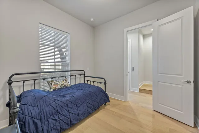 a bedroom with a bed window and walk in closet