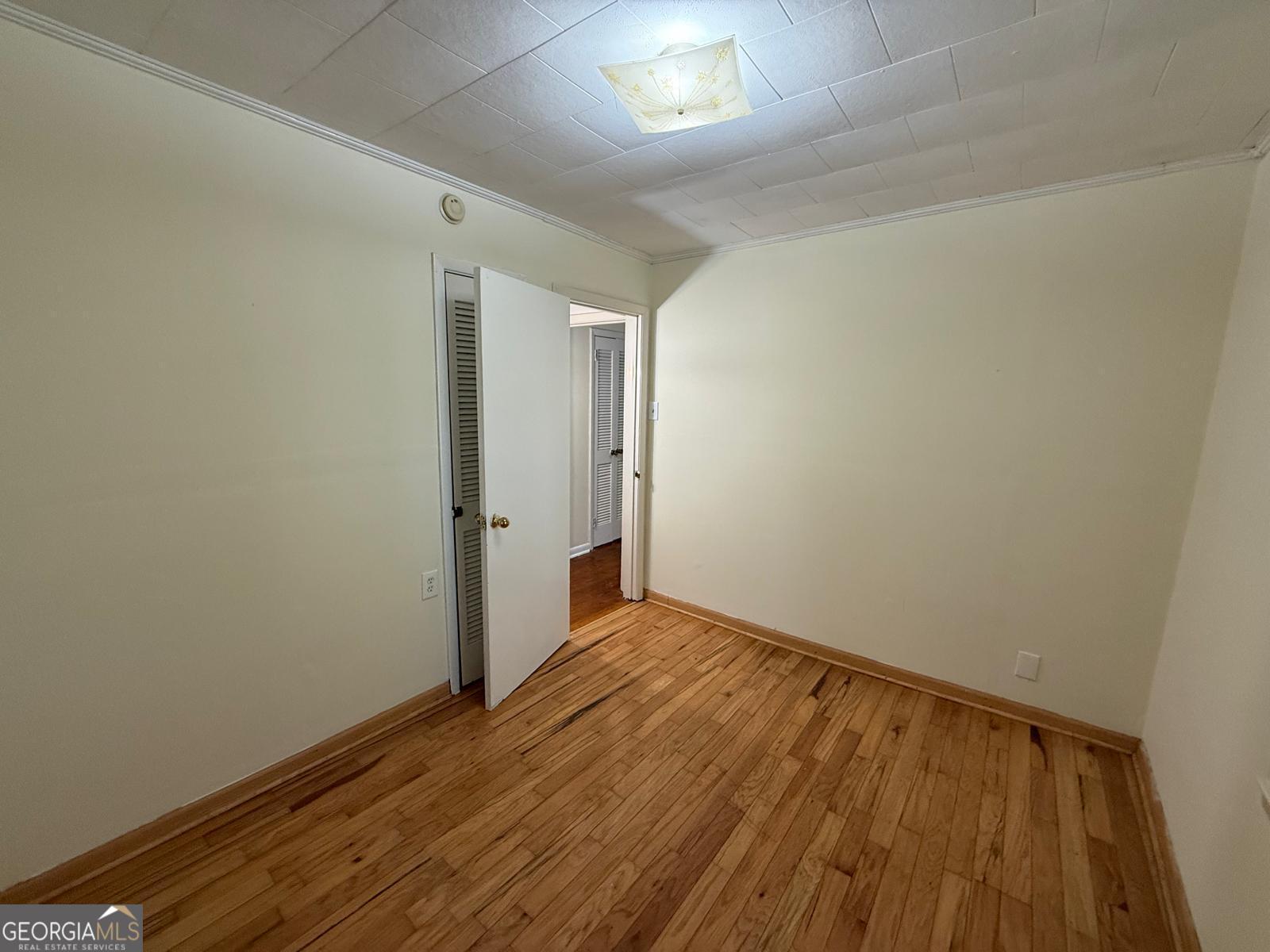 14661 Veterans Memorial Highway Villa Rica, GA 30180 - Photo 12 of 14 a view of an empty room with wooden floor