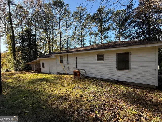 a backyard of a house with large trees