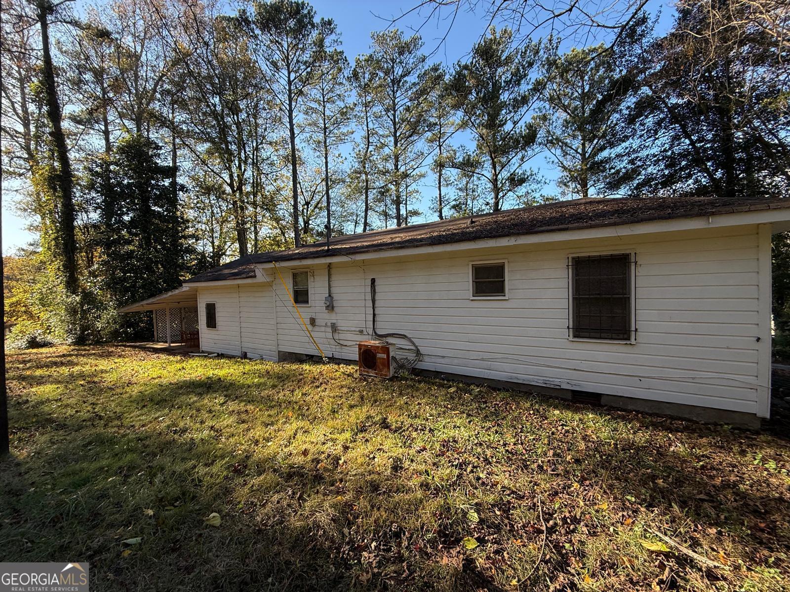 14661 Veterans Memorial Highway Villa Rica, GA 30180 - Photo 14 of 14 a backyard of a house with large trees