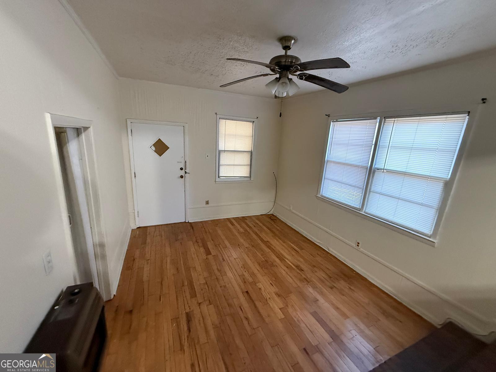 14661 Veterans Memorial Highway Villa Rica, GA 30180 - Photo 5 of 14 wooden floor in an empty room with a window