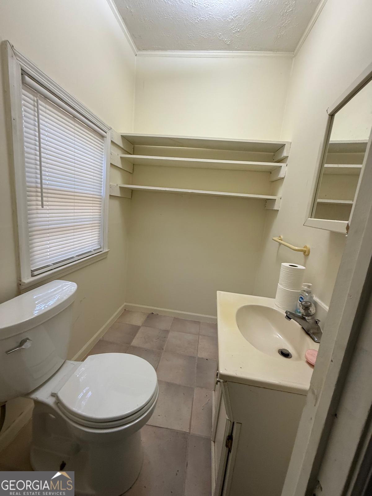 14661 Veterans Memorial Highway Villa Rica, GA 30180 - Photo 10 of 14 a bathroom with a toilet sink and mirror