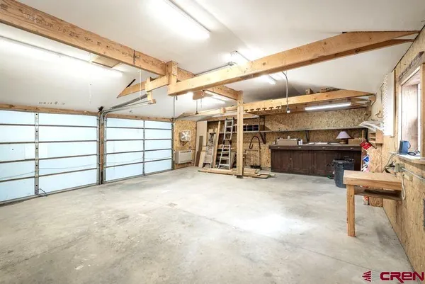 a kitchen with stainless steel appliances kitchen island granite countertop a refrigerator a sink a stove and island