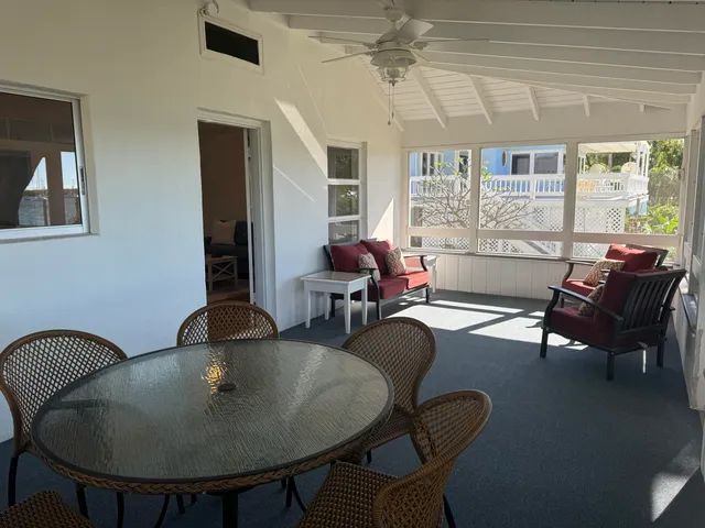 a living room with stainless steel appliances furniture and a kitchen view