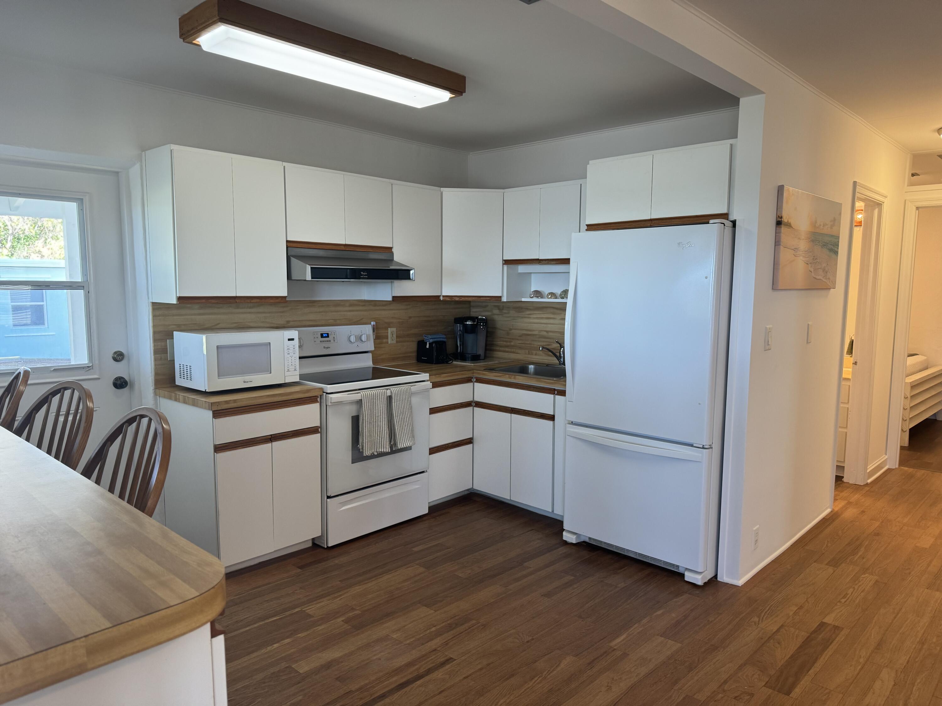 184 Harborview Drive Tavernier, FL 33070 - Photo 15 of 23 a kitchen with white cabinets and white appliances
