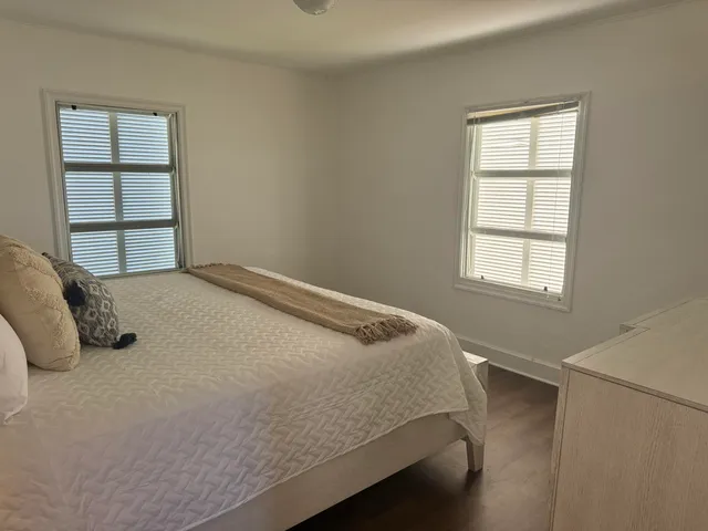 a bed sitting in a bedroom next to a cabinet