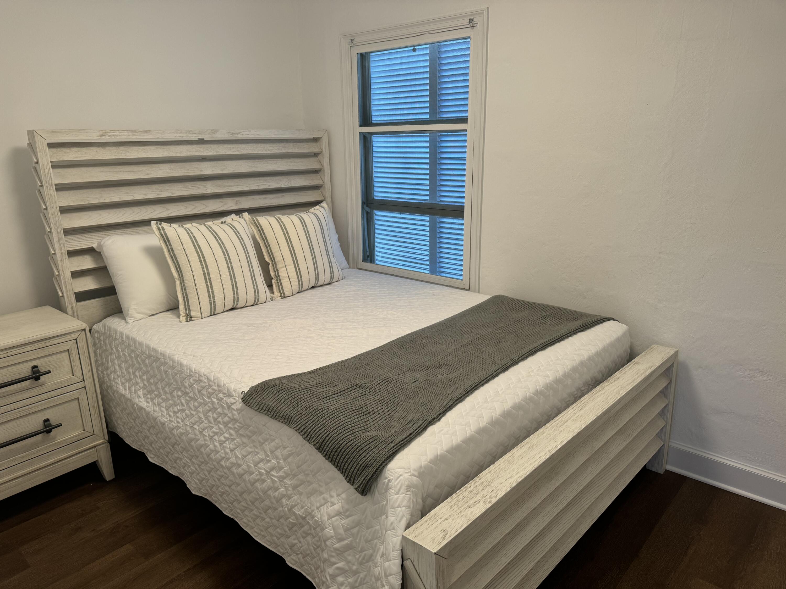 184 Harborview Drive Tavernier, FL 33070 - Photo 20 of 23 a bed sitting in a bedroom next to a cabinet