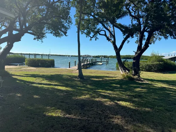 a view of a pathway both side of building with yard