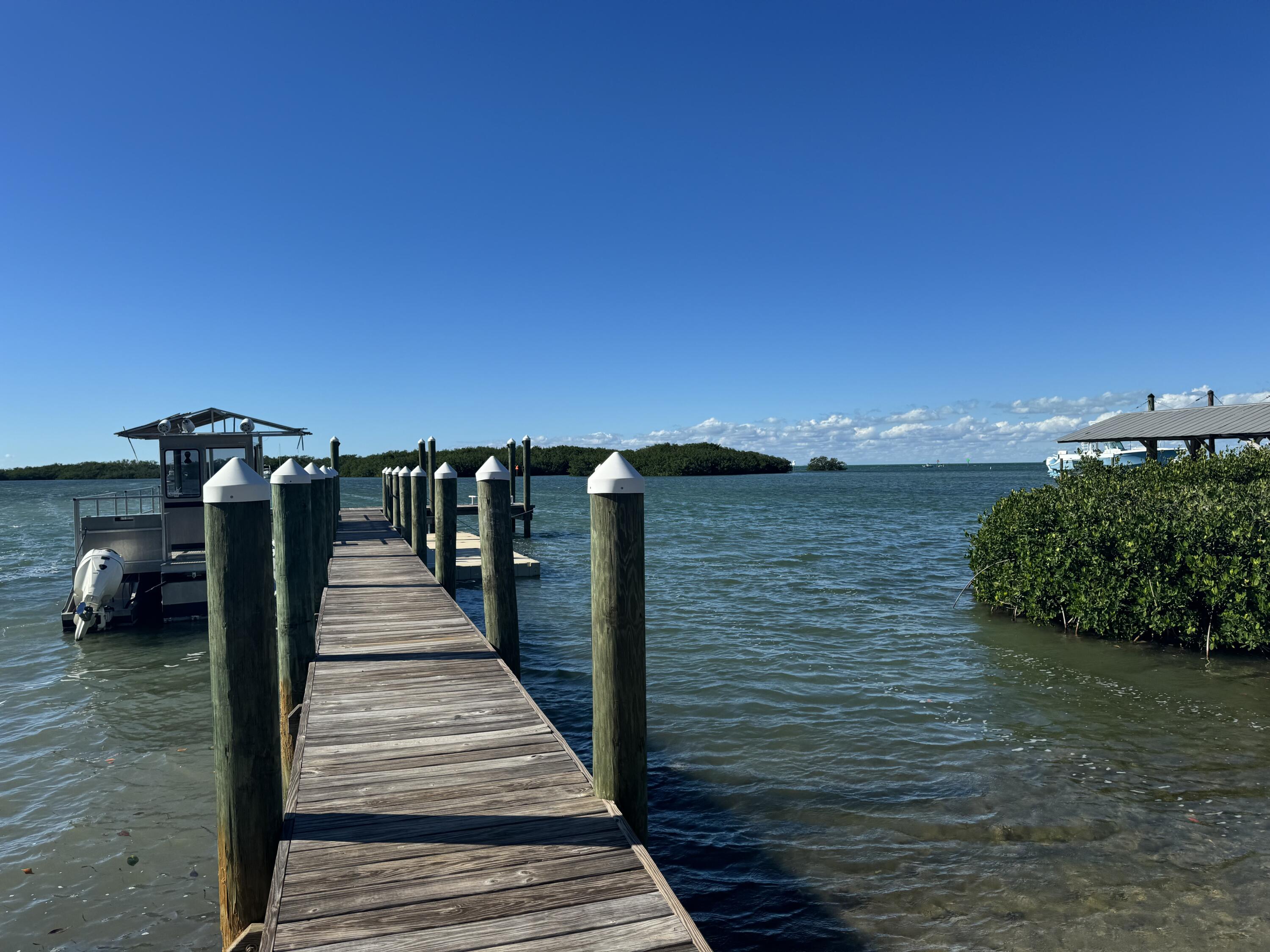 184 Harborview Drive Tavernier, FL 33070 - Photo 4 of 23 a view of a pathway both side of building with yard