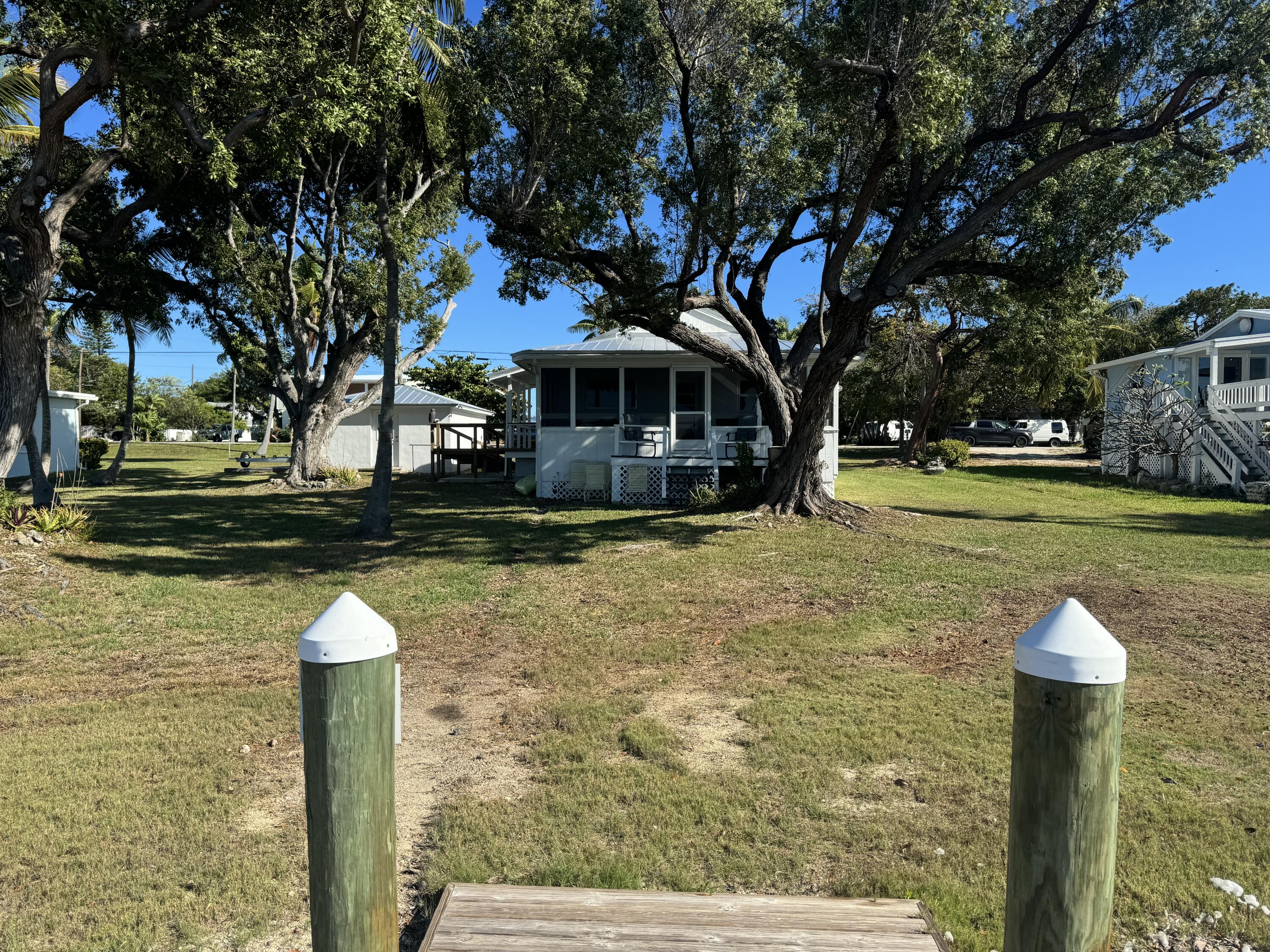 184 Harborview Drive Tavernier, FL 33070 - Photo 5 of 23 a front view of a house with a yard