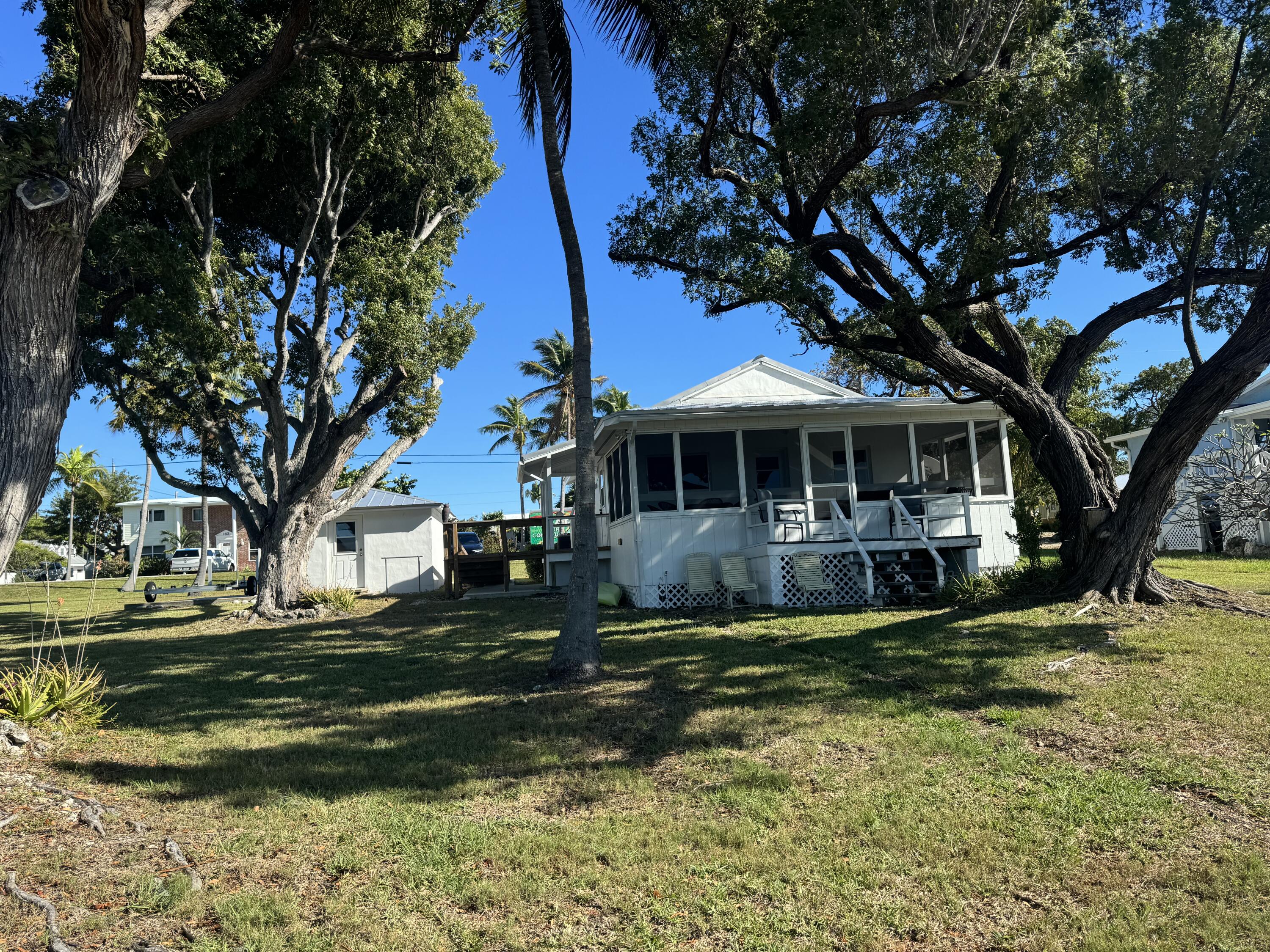 184 Harborview Drive Tavernier, FL 33070 - Photo 6 of 23 a front view of a house with a garden
