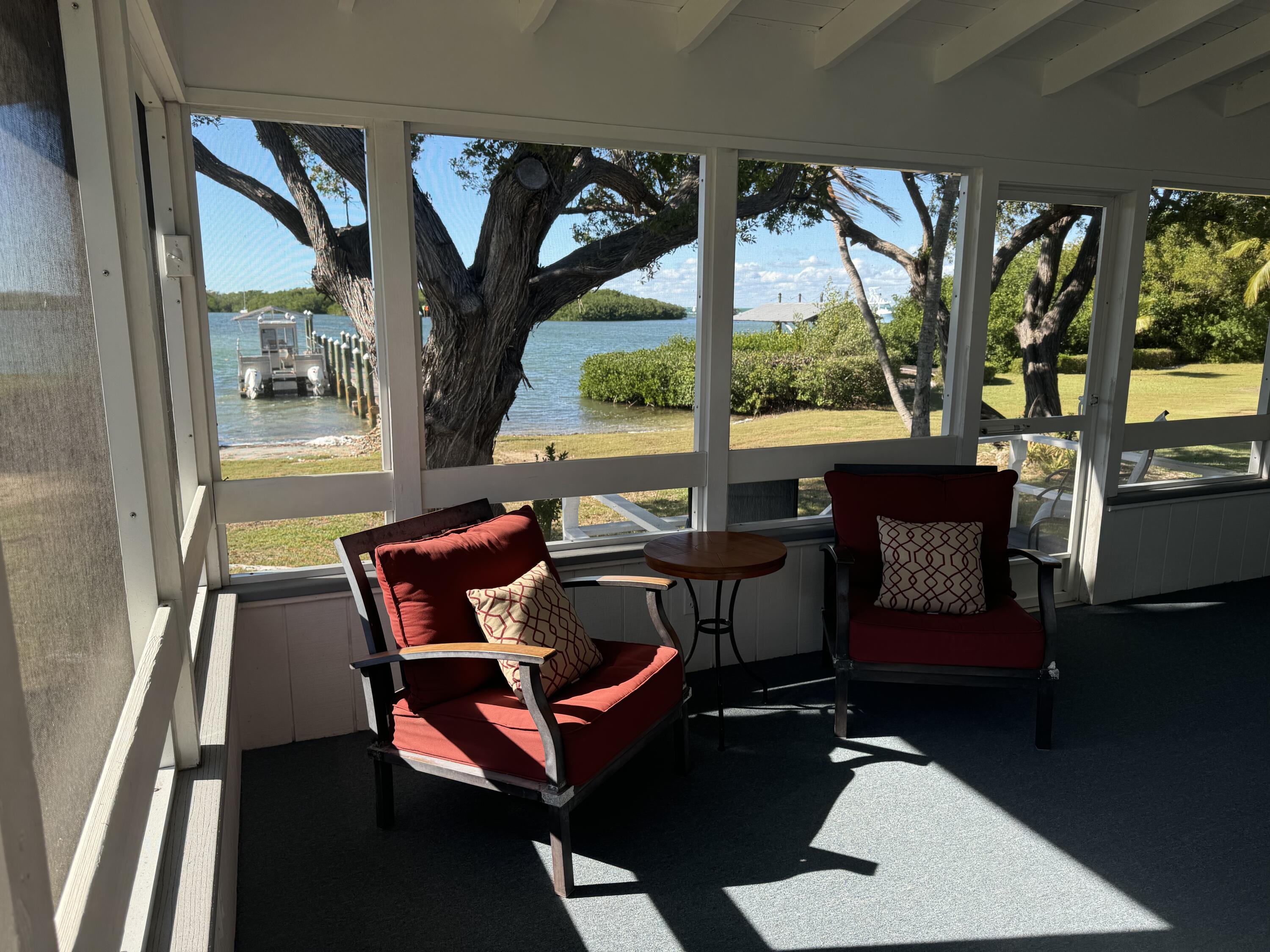184 Harborview Drive Tavernier, FL 33070 - Photo 10 of 23 a balcony with wooden floor and outdoor seating