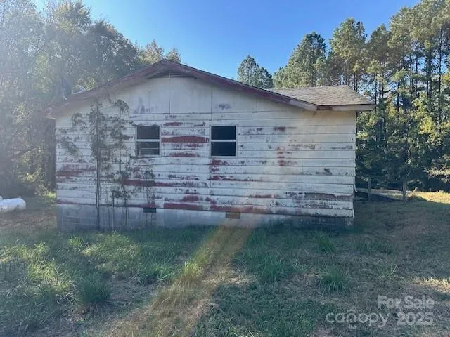 a view of a wooden house with a yard