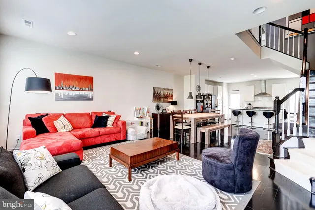 a kitchen with kitchen island a stove a sink a refrigerator and cabinets