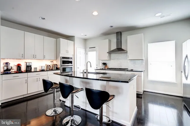 a view of a porch with a door and wooden bench