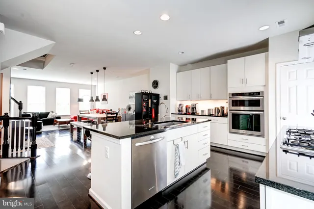 a view of a hallway with wooden floor and stairs