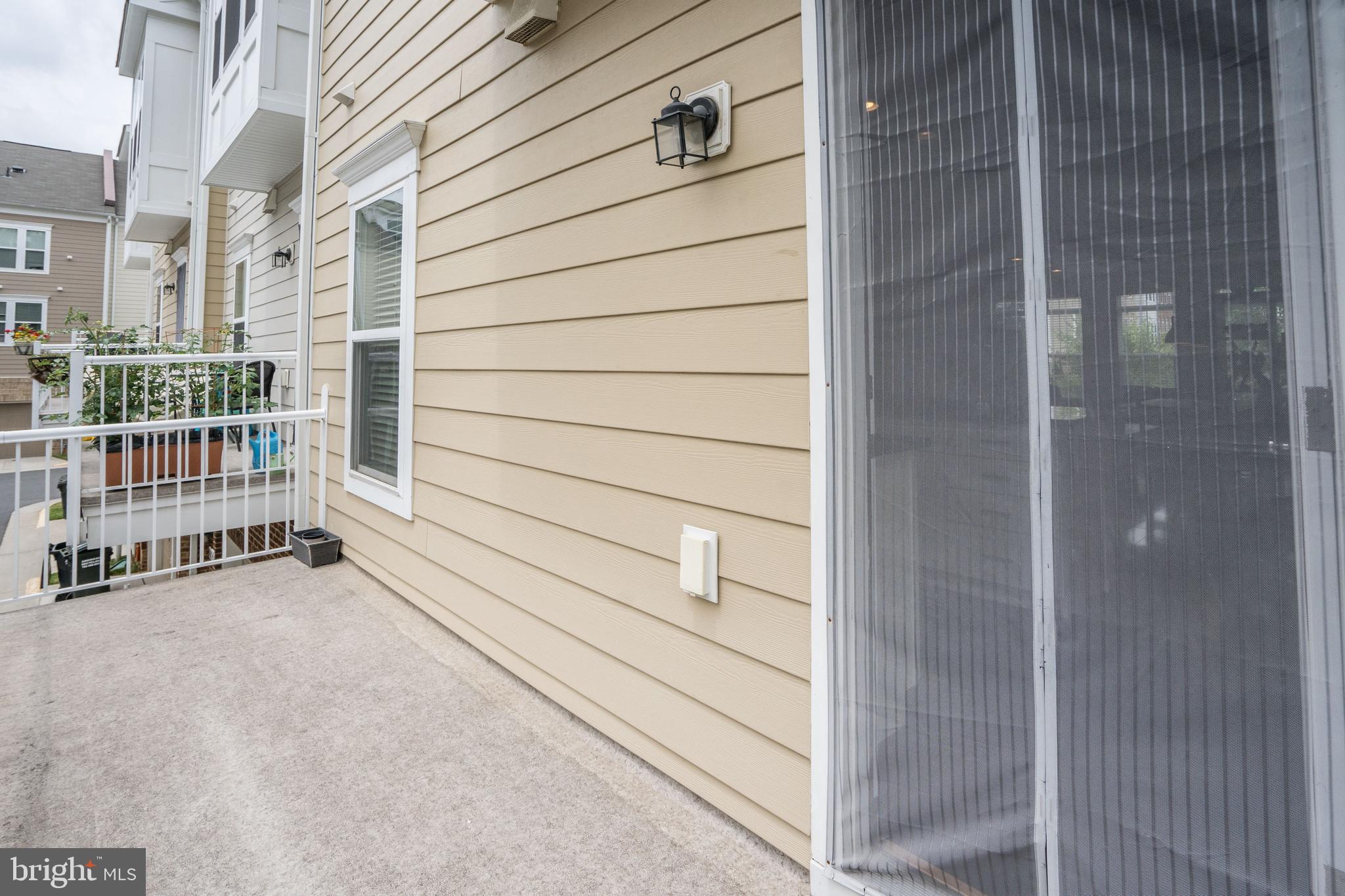 9652 Pullman Place Fairfax, VA 22031 - Photo 17 of 39 a view of a porch with a door and wooden bench