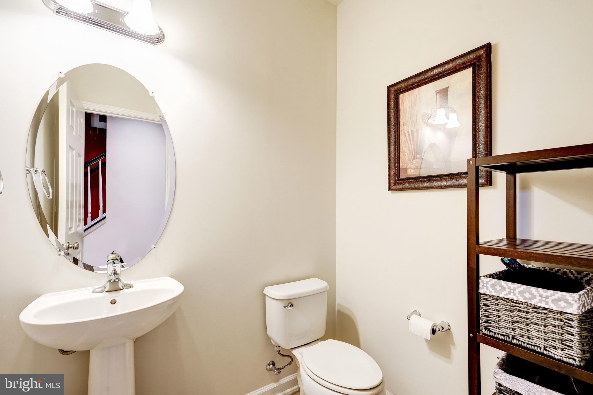 9652 Pullman Place Fairfax, VA 22031 - Photo 33 of 39 a bathroom with a toilet sink and mirror