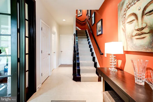 a living room with furniture pool table flat screen tv and a wooden floor
