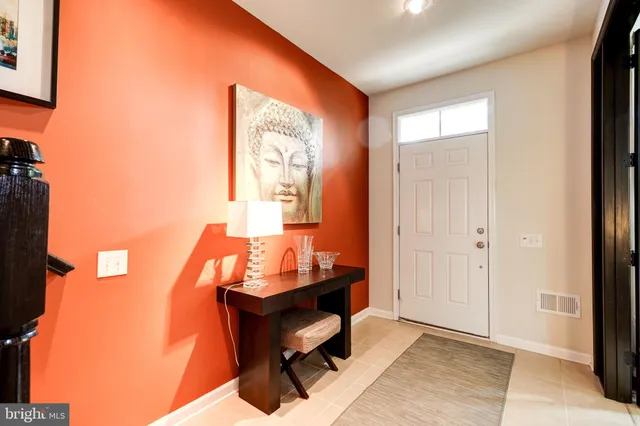 a kitchen with stainless steel appliances a stove a chimney a sink and cabinets