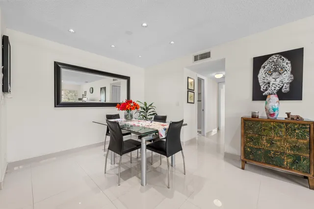 a view of a dining room with furniture and a chandelier