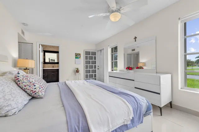 a bedroom with a large bed and wooden floor