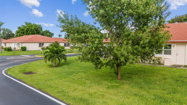 a swimming pool with outdoor seating and yard