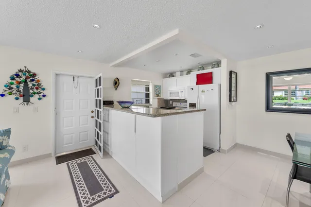 a kitchen with refrigerator and cabinets