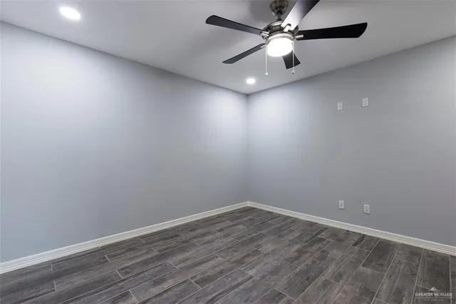 an empty room with a fan and a fan