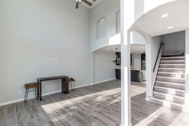 a view of a hallway with wooden floor and staircase