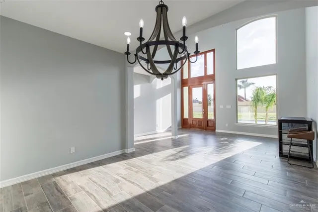 a view of a livingroom with wooden floor and a window