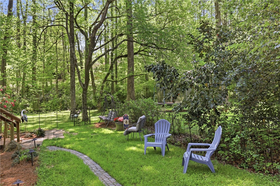 110 Shaftsbury Road Clemson, SC 29631 - Photo 23 of 38 A tranquil backyard oasis featuring a stone pathway and lush greenery for outdoor enjoyment.