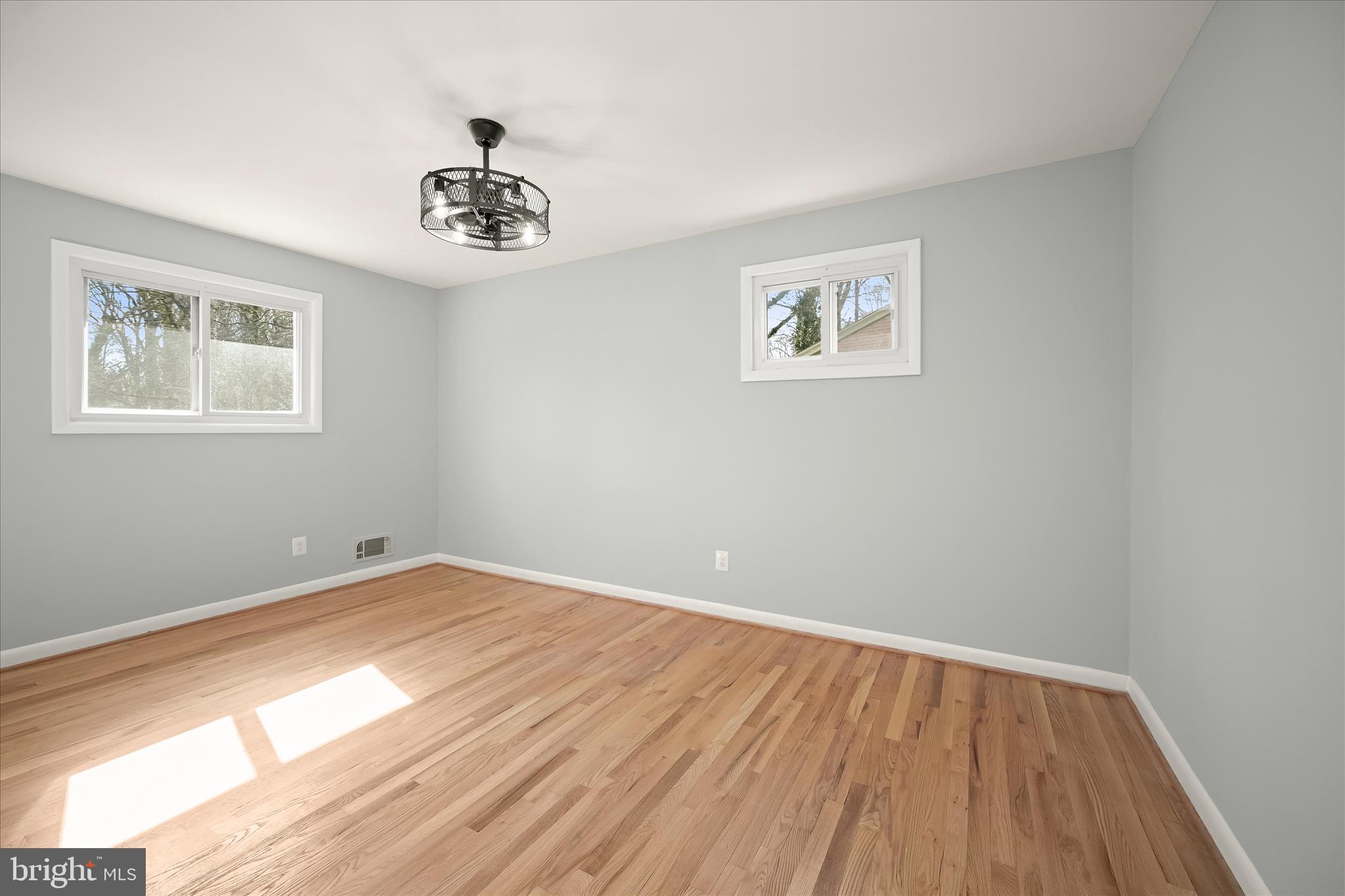 9720 Hedin Drive Silver Spring, MD 20903 - Photo 32 of 79 a view of a big room with wooden floor and a window