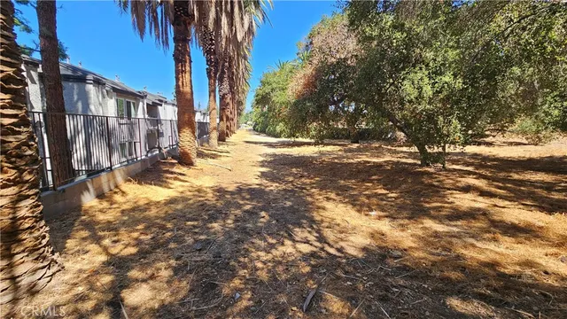 a view of a yard with wooden fence