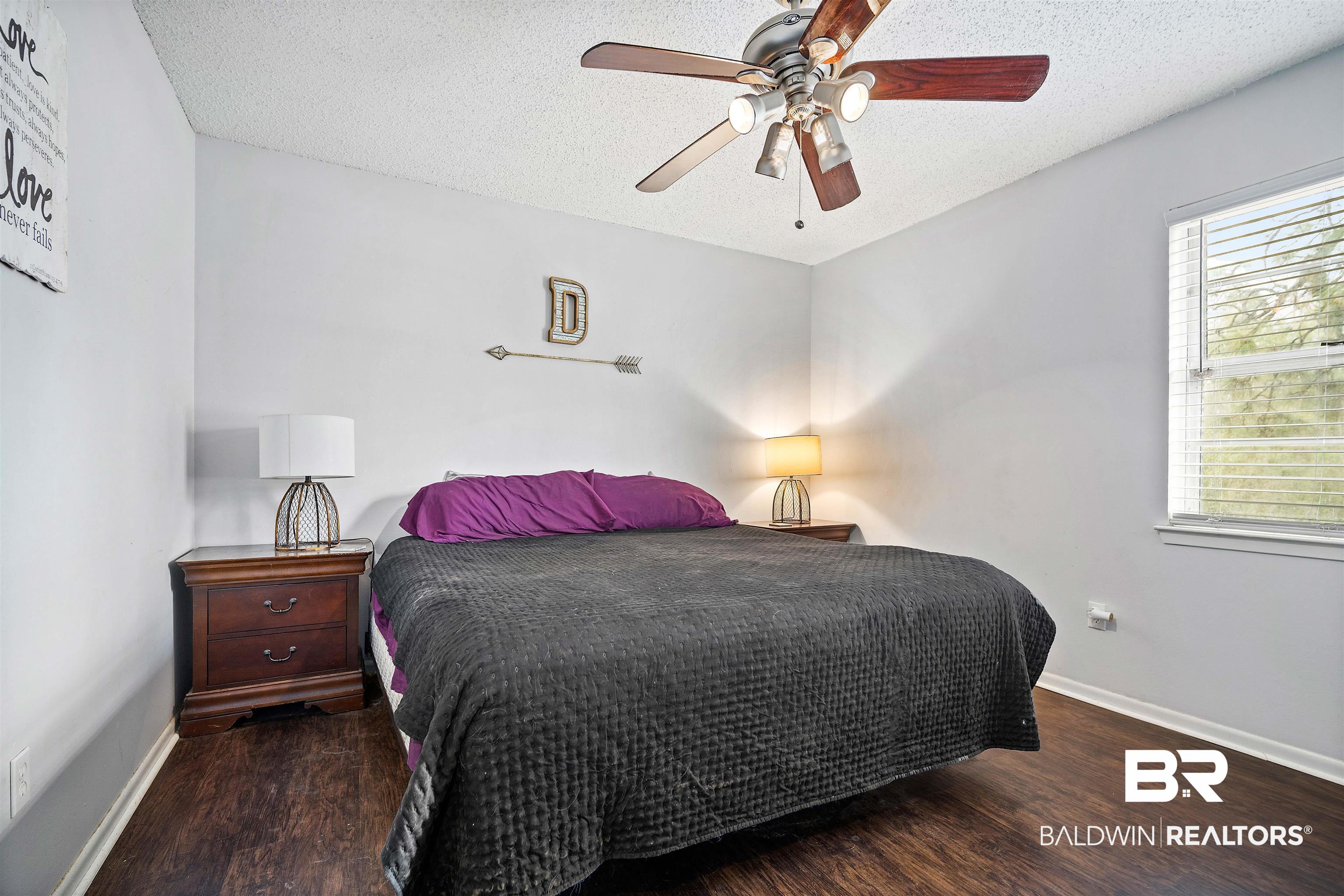 5110 Wilmer Road Wilmer, AL 36587 - Photo 15 of 24 Bedroom featuring a textured ceiling, dark hardwood / wood-style flooring, and ceiling fan