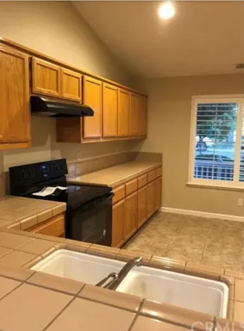 a kitchen with stainless steel appliances granite countertop a stove and a cabinet