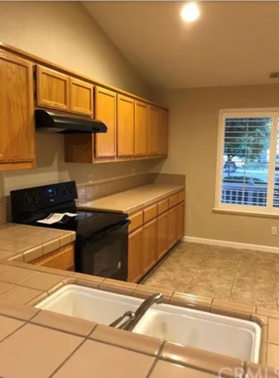 1787 Edgewood Court Merced, CA 95340 - Photo 3 of 9 a kitchen with stainless steel appliances granite countertop a stove and a cabinet
