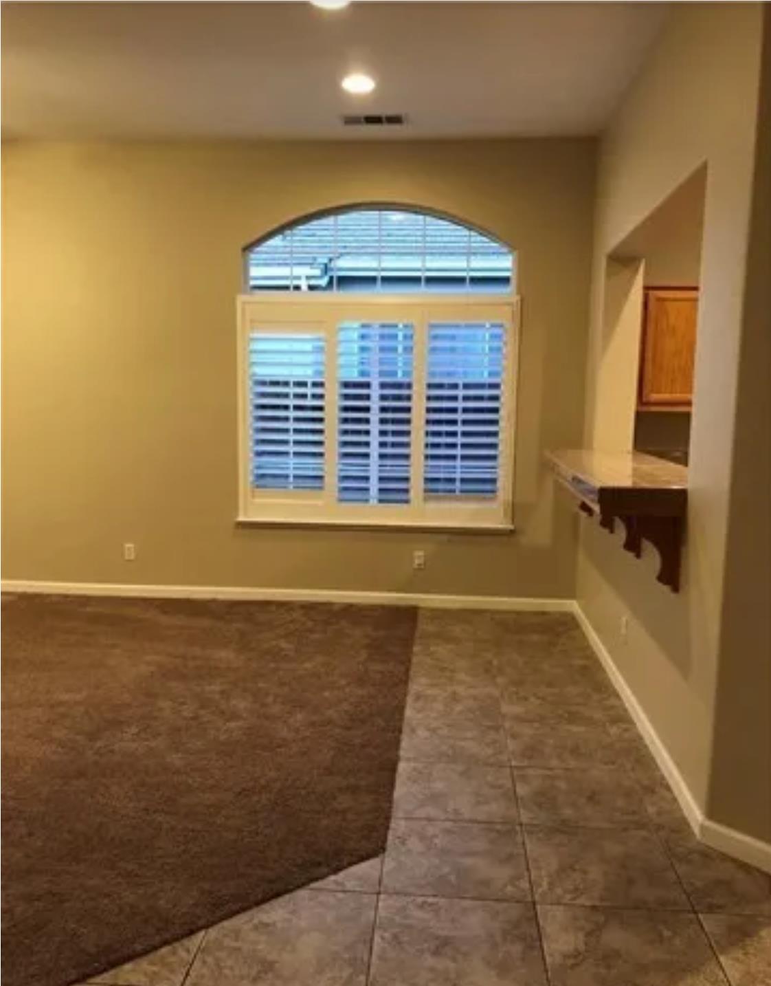 1787 Edgewood Court Merced, CA 95340 - Photo 5 of 9 a view of an empty room with a fireplace and a window