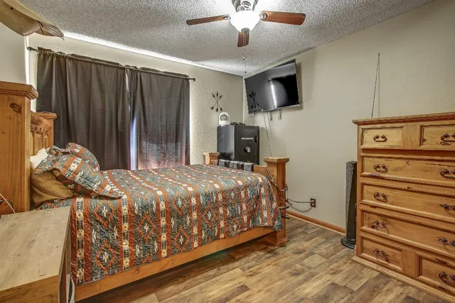 a bed sitting in a bedroom and tv