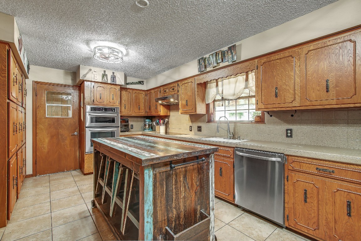 105 Frederick Lane Thorndale, TX 76577 - Photo 5 of 12 a kitchen with a stove top oven sink and cabinets